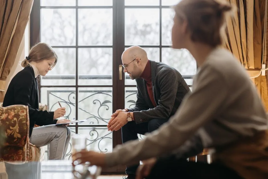 A psychologist and teenage patient in a counseling session, focusing on mental health support.