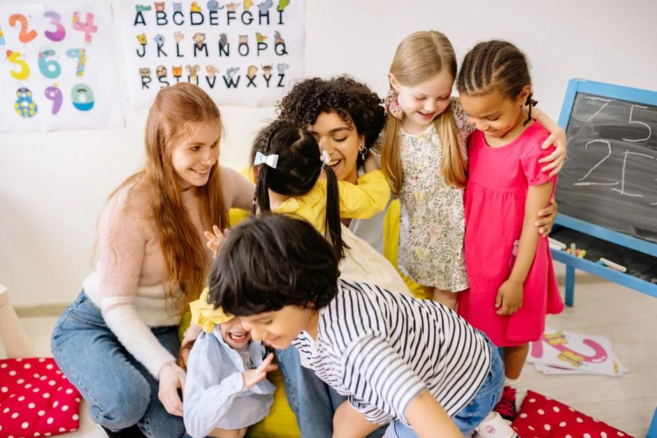 Happy preschoolers and teacher bonding in a colorful classroom setting, fostering friendship and education.