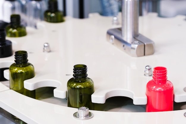 Pharmaceutical industry medicine pills are filling in the bottle on production line machine conveyor at the medical factory selective focus