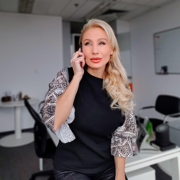 Portrait of beautiful young woman standing against wall