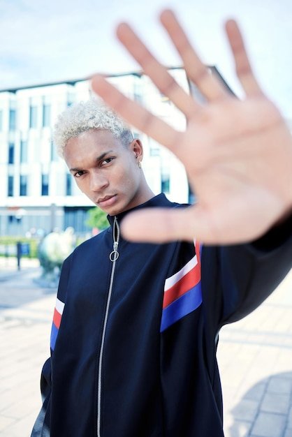 Portrait of black man hand and urban fashion street and modern style cool in cityscape African American person gen z youth and trendy with city background frame and face of young model