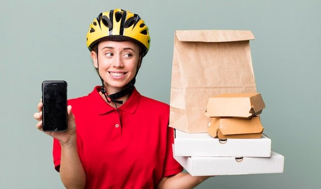 Pretty blonde deliverywoman with a paper bag
