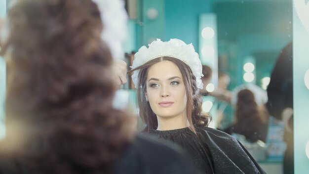 Professional hairstylist making wedding hairstyle