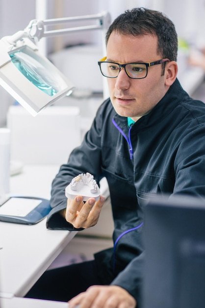 Prosthetic dentistry technician working in his office