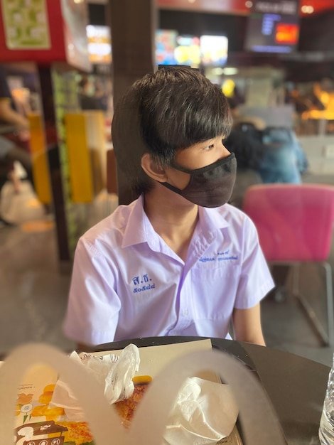 Rear view of woman using mobile phone in restaurant