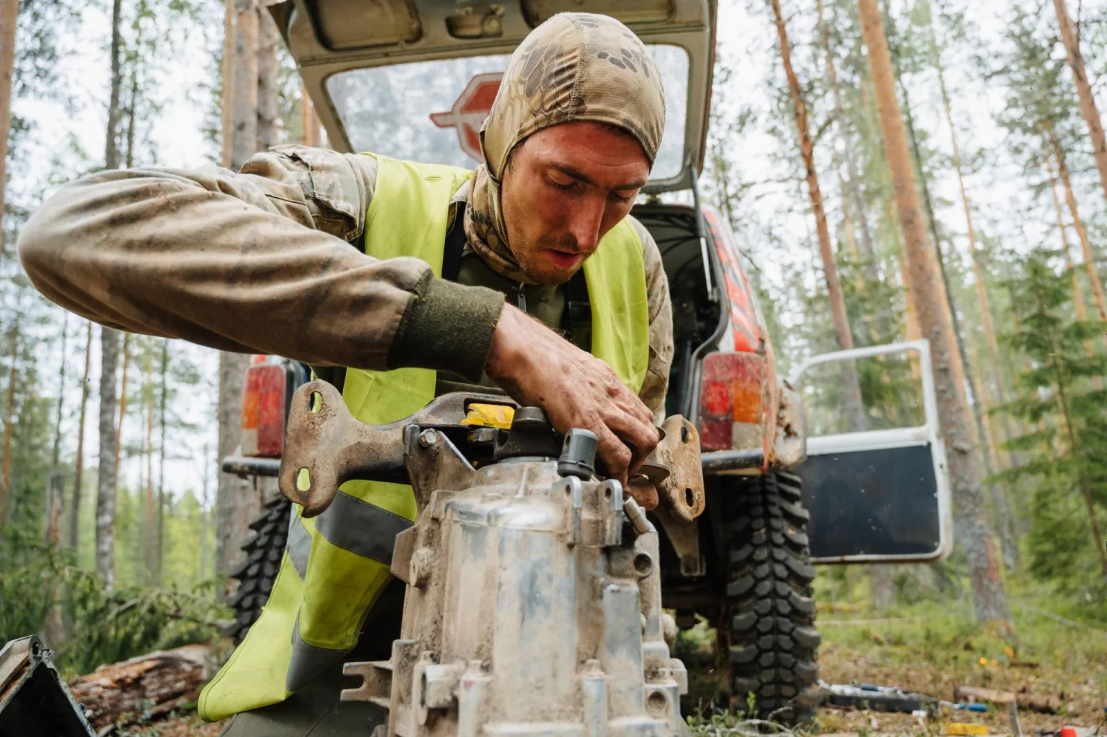 REPUBLIC OF KARELIA RUSSIA CIRCA JUNE 2022 Offroad tournament Ladoga Trophy 2022 around Lake Ladoga A racer repairs the transmission of a jeep SUV