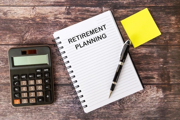 Retirement Planning on Note Pad With calculator and Pen
