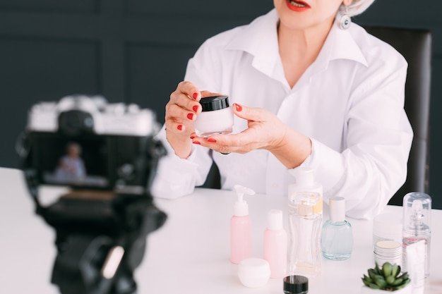 senior beauty blogger. aged woman making video review