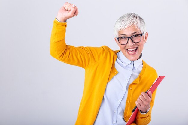 Senior business women with clipboard and document in hands
