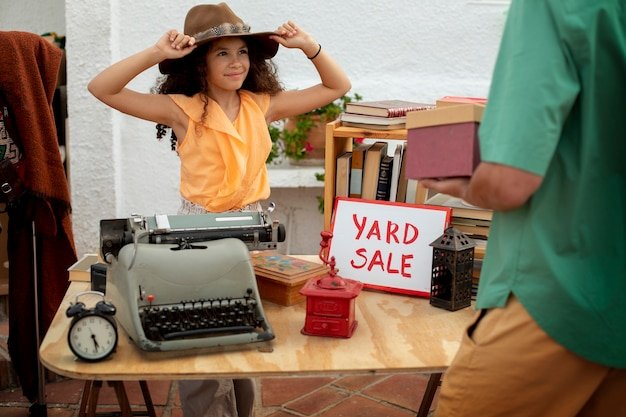 Side view man and girl at garage sale