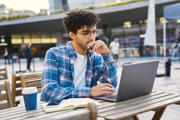 Smart pensive middle eastern student studying, exam preparation, online education concept