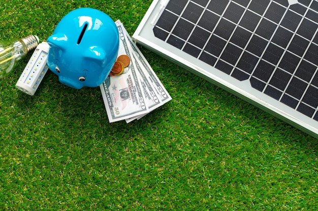 Solar panel model and piggy bank close up