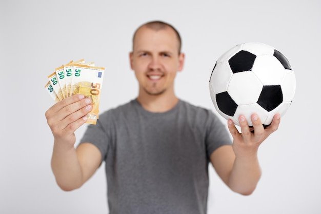 Sport betting success win and money concept happy young man with euro money and soccer ball