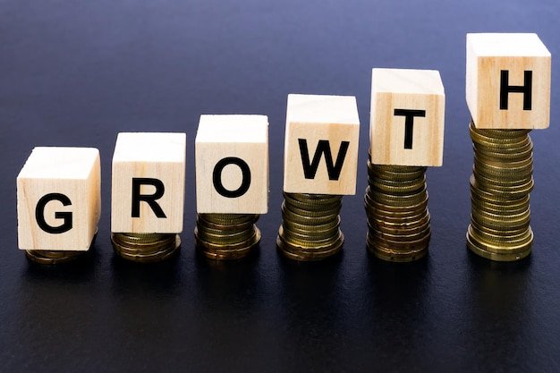 Stack of coins with growth text on table