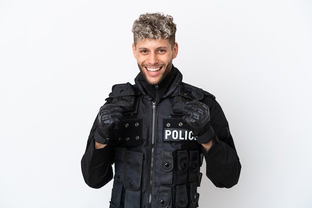 SWAT caucasian man isolated on white background celebrating a victory in winner position