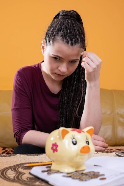 Teenagers were left with the last pennies of spending savings until the end of a long month The girl holds a dime in her fingers hoping for a better future