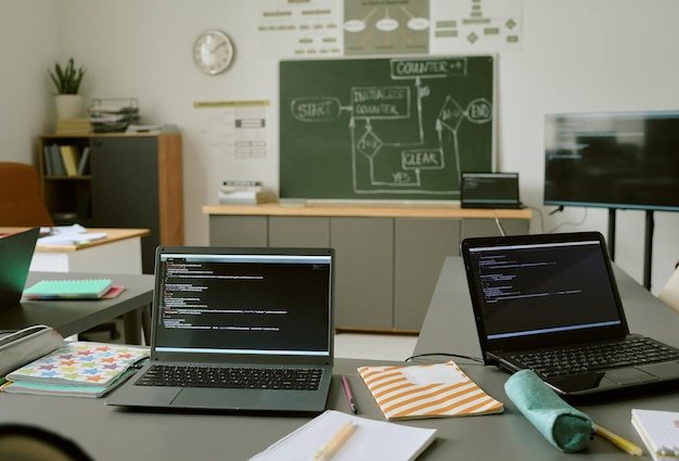 Two Laptops Displaying Programming Code in Classroom during Lesson