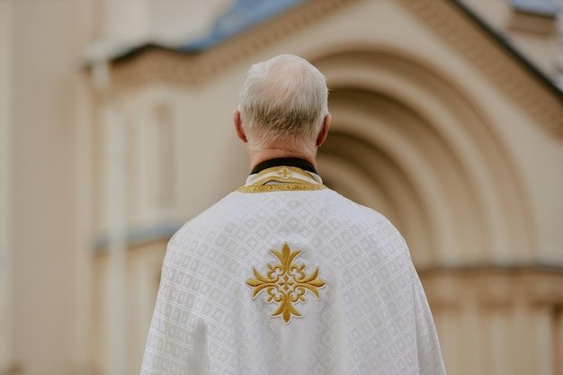 Unrecognizable priest standing outdoors