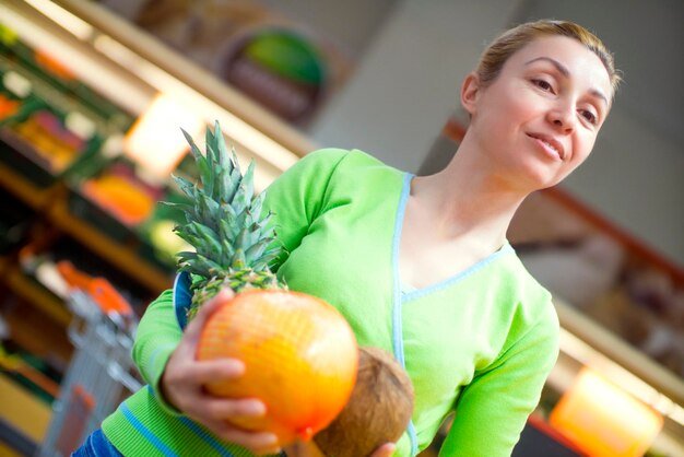 Woman doing shopping of merchandise in supermarket
