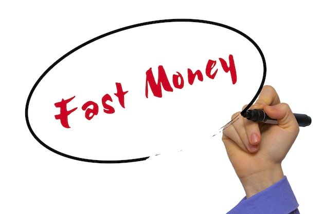 Woman Hand Writing Fast Money on blank transparent board with a marker isolated over white background. Business concept. Stock Photo