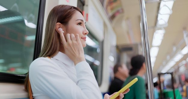 Woman taking self photograph with smart phone at the airport
