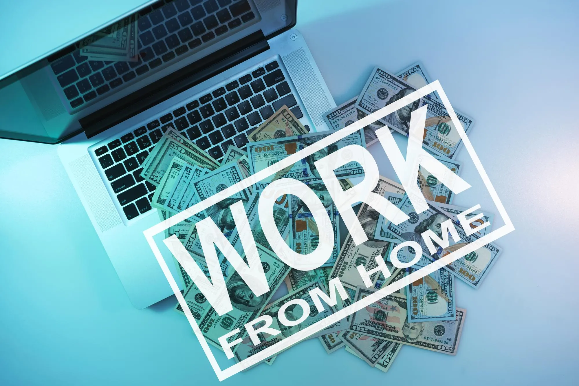 Words work from home on a cloused silver laptop and dollars cash night online in the color light on