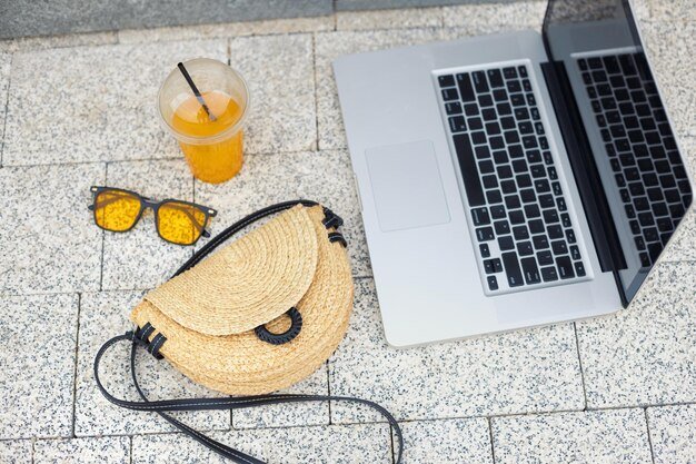 Working place in the urban city park Freelancer on vacation Summer accessories business woman