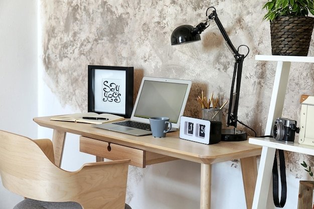 Workplace with laptop on table in modern room