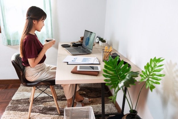 Young beautiful asian woman working at home