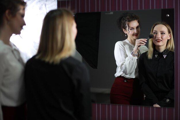 Young girl with a makeup artist