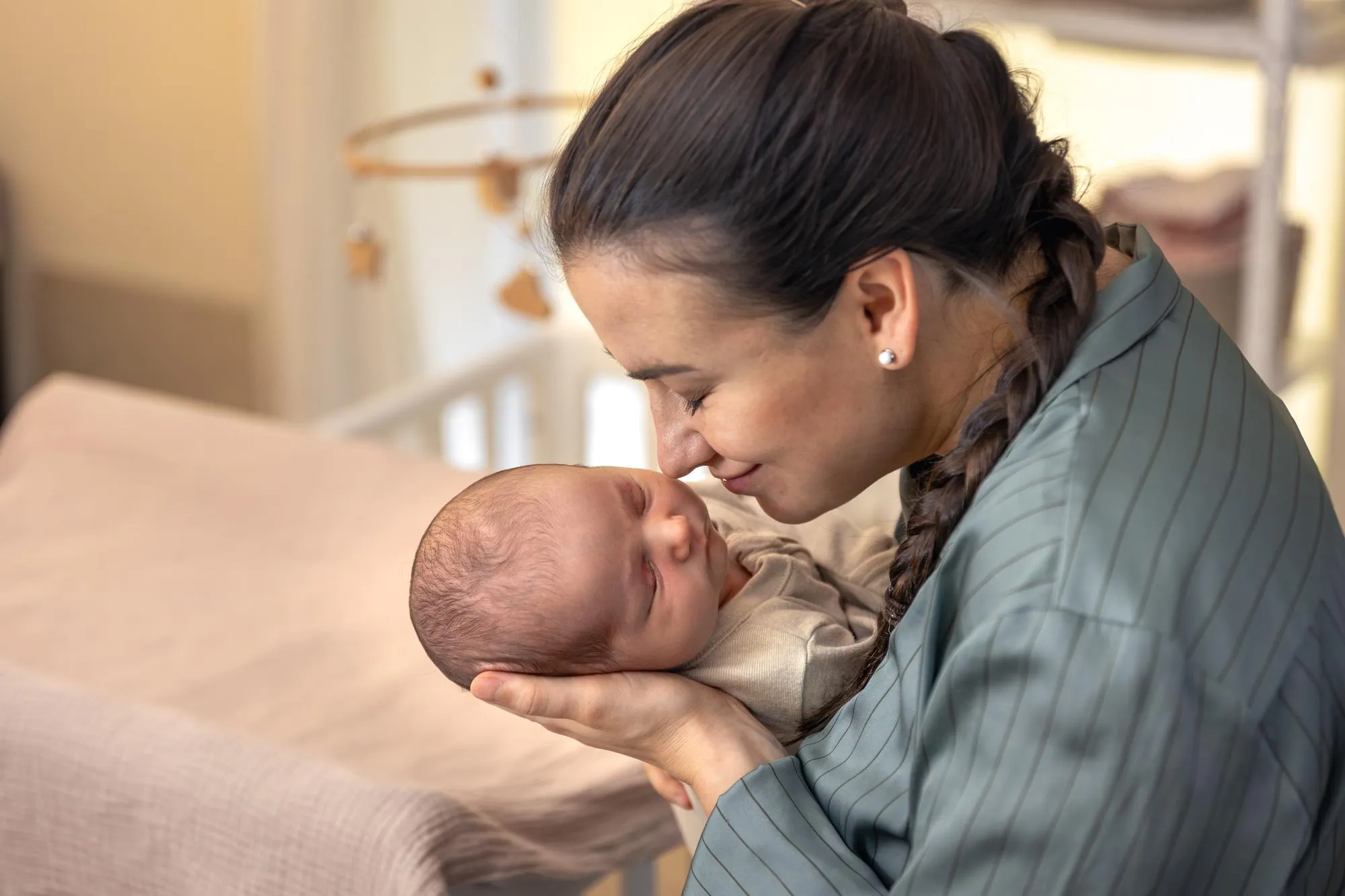 A young mother with a newborn baby Newborn baby