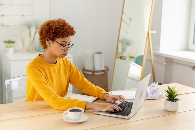 Young woman using laptop at table