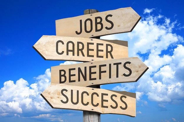 Jobs career benefits success wooden signpost with four arrows sky with clouds in background
