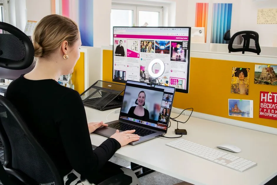 Woman engaged in a video call at her office desk, using technology for remote work and communication.