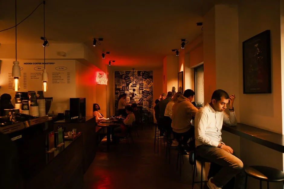 A cozy café in Barcelona showcasing modern decor and social ambiance with warm lighting and casual seating.