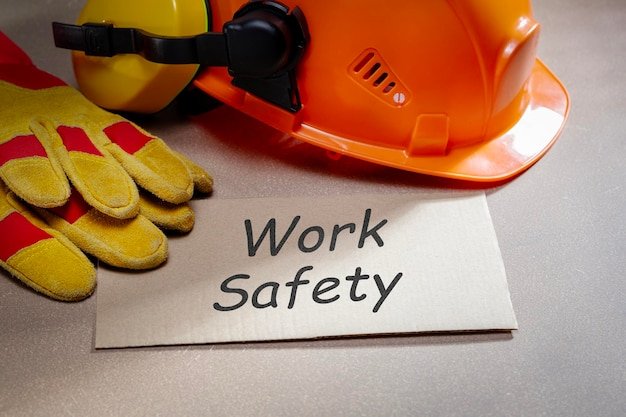 work safety word written on paper list and work safety protection equipment on the desk