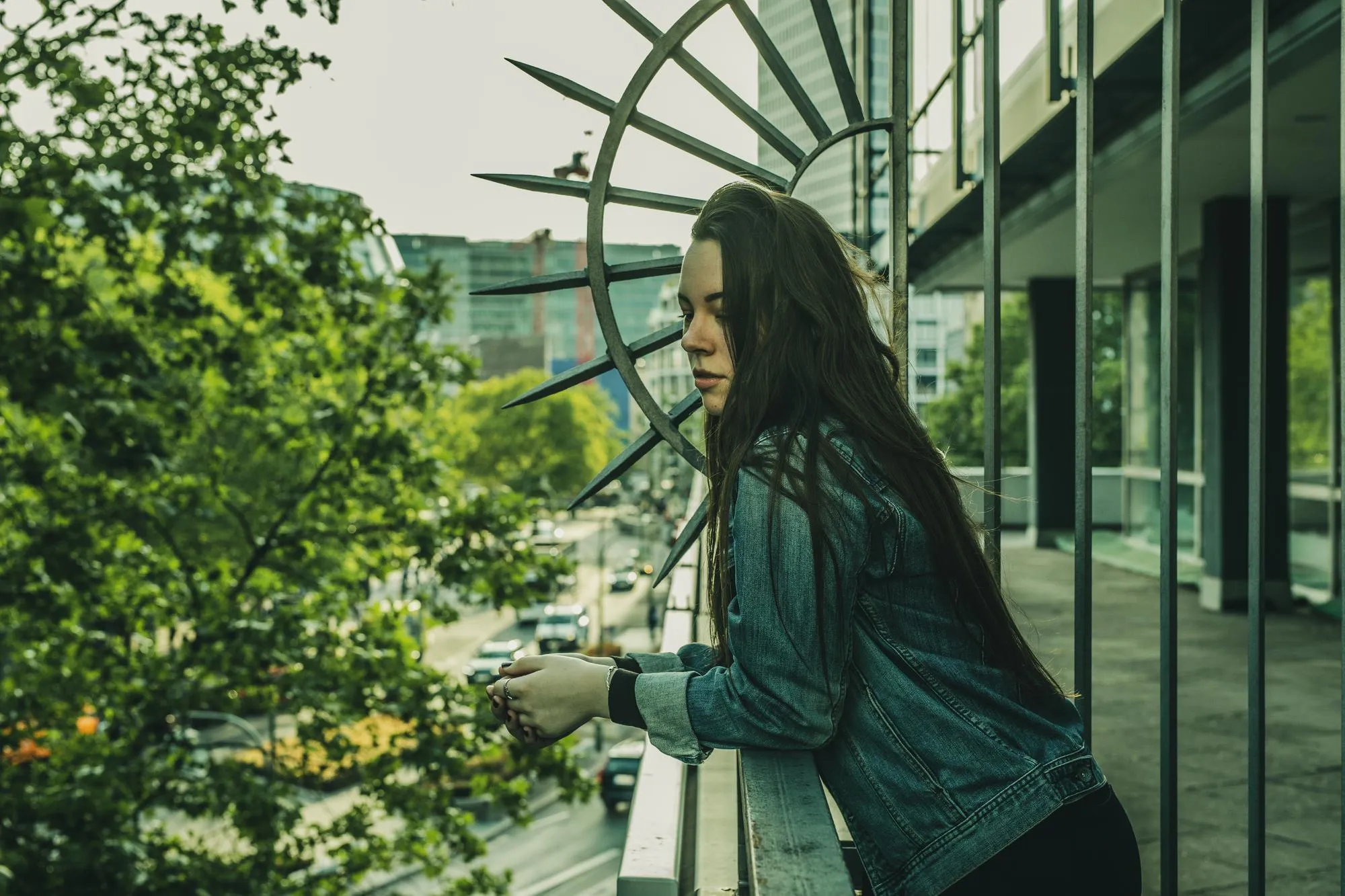 Young woman standing in balcony in city