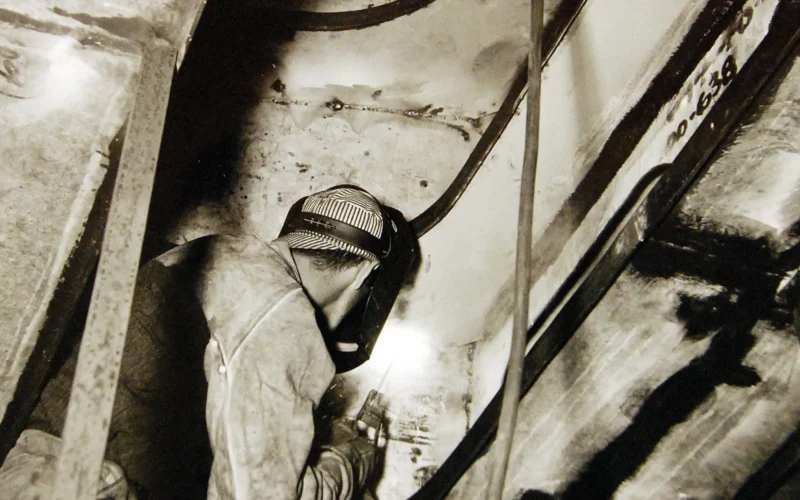 Lot-2068-1: Norfolk Naval Shipyard, Norfolk, Virginia. Shipbuilding. The welder is a valuable man in our defense industries. This one is working on the bow section of a new destroyer for Uncle Sam’s Navy. Welding insures durability, cuts down weight and means a considerable saving in steel. Office of War Information photograph, circa October 1941. Courtesy of the Library of Congress. (2016/04/14).