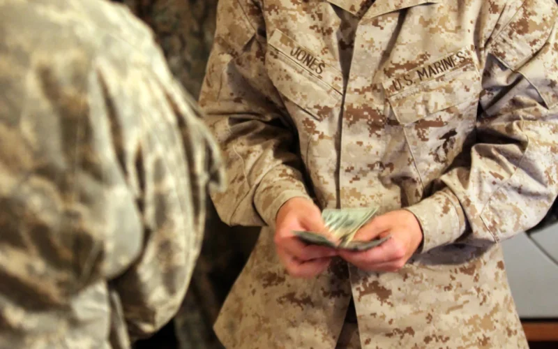U.S. Marine Corps Lance Cpl. Austin Jones, a disbursing clerk, counts money before handing it to a U.S. Soldier at Forward Operating Base (FOB) Edinburgh, Afghanistan, June 2, 2011. Jones is one of the two disbursing clerks who were moved to FOB Edinburgh to open an office that allows troops quick and easy access to their money.