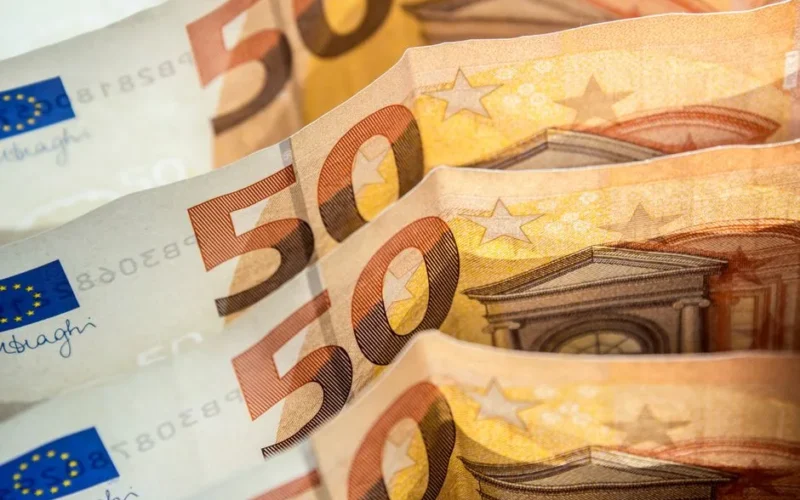 Detailed shot of fifty euro bills highlighting European currency and finance concept.