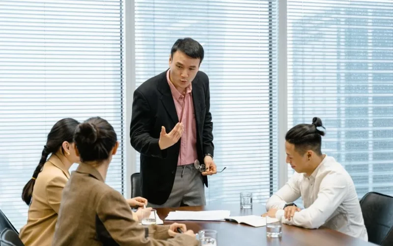 A group of professionals engaged in a business meeting in a modern office setting.