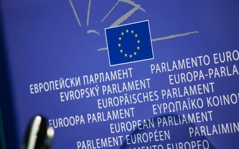 Close-up view of the European Union flag with multilingual text showing European Parliament.