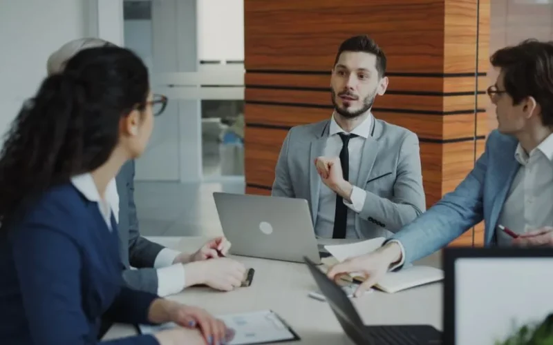 Professional business team collaborating in a modern office meeting.