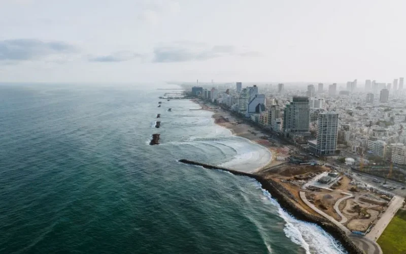 Stunning aerial view of Tel Aviv skyline and beach, showcasing vibrant city and coastline.