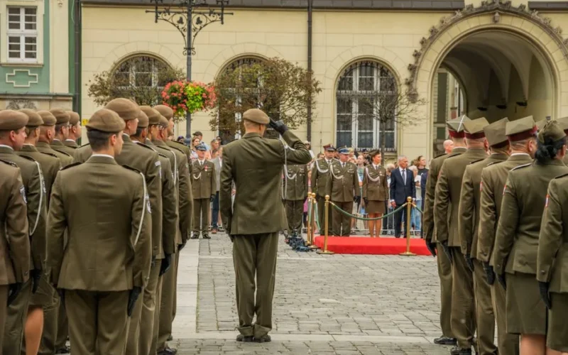 A formal military ceremony featuring Polish soldiers in uniform in Wrocław's historic square.