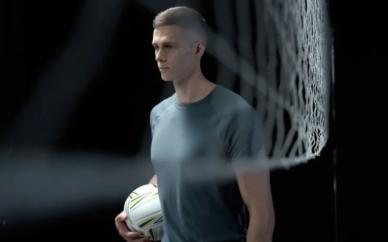 Profile image of a male volleyball player holding a ball in a studio setting with a net.