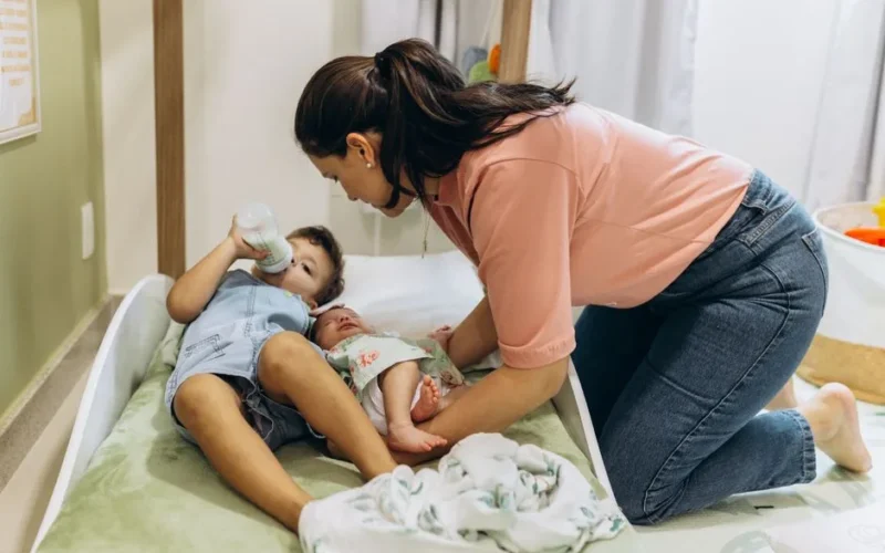 A mother tending to her children in a peaceful nursery setting.